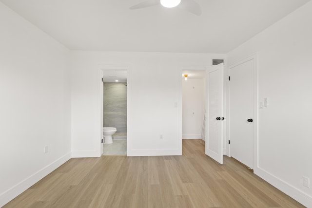 unfurnished bedroom featuring light hardwood / wood-style flooring, ensuite bath, and ceiling fan