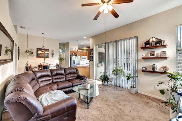 living room featuring ceiling fan and light colored carpet