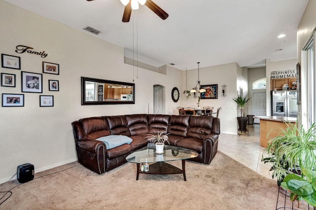 carpeted living room with ceiling fan