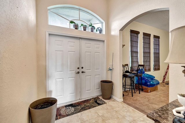 entryway with light tile patterned flooring