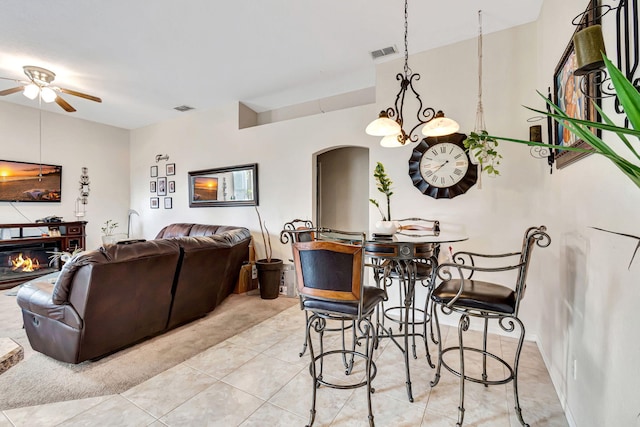 tiled dining area with ceiling fan