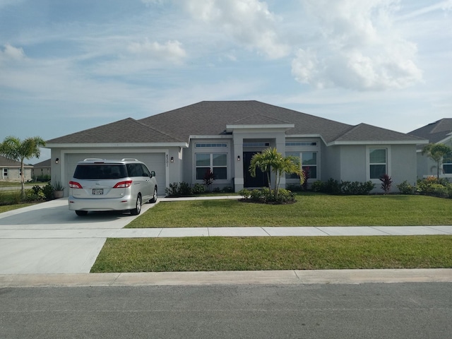 single story home with an attached garage, a front yard, and stucco siding