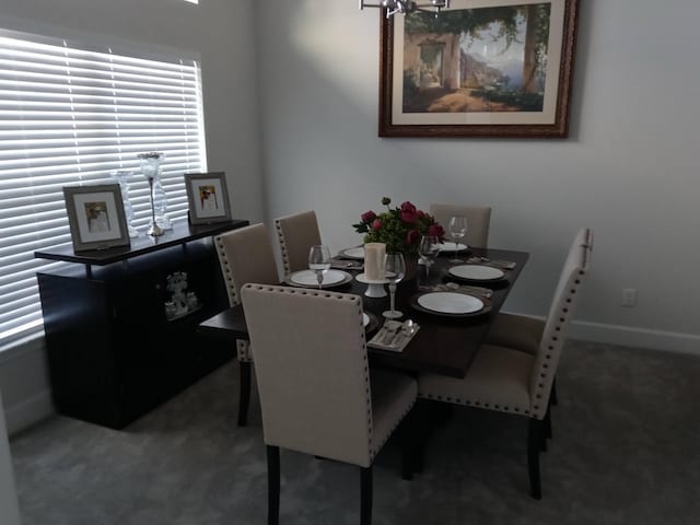 carpeted dining area with baseboards