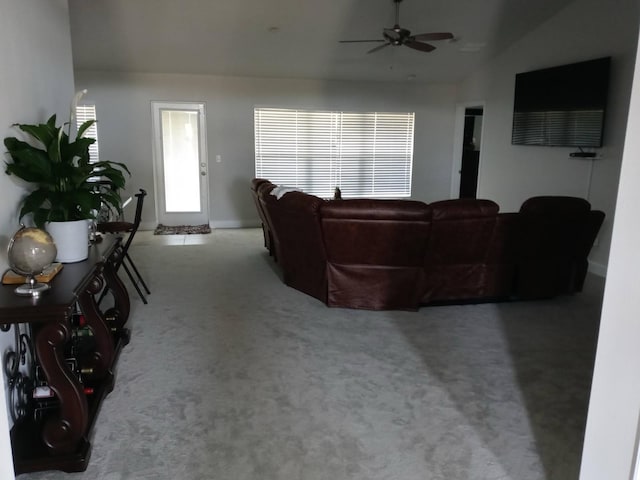 carpeted living room featuring vaulted ceiling and ceiling fan