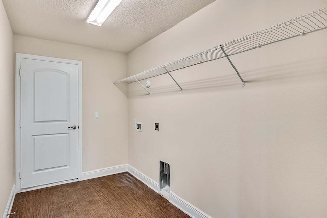 clothes washing area featuring laundry area, baseboards, dark wood-type flooring, a textured ceiling, and washer hookup