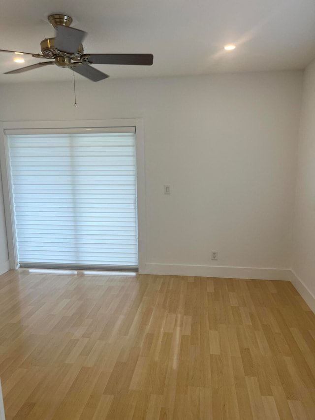 spare room with light hardwood / wood-style floors and ceiling fan