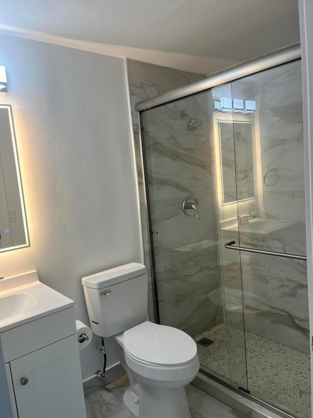 bathroom with walk in shower, vanity, and toilet