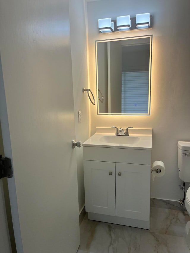 bathroom featuring vanity and toilet