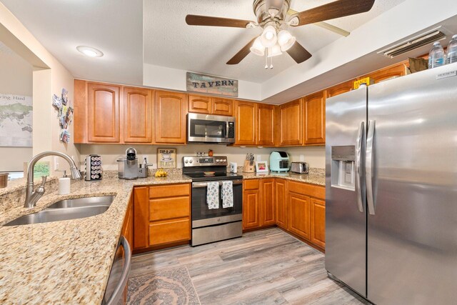 3500 Twin Lakes Ter Unit 106, Fort Pierce, FL 34951 - kitchen featuring light stone counters, stainless steel appliances, ceiling fan, and a sink