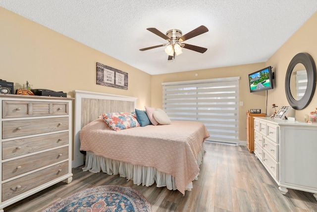 3500 Twin Lakes Ter Unit 106, Fort Pierce, FL 34951 - bedroom with light wood-type flooring, ceiling fan, and a textured ceiling