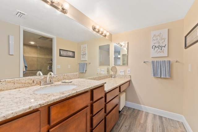 bathroom featuring walk in shower, vanity, and hardwood / wood-style flooring