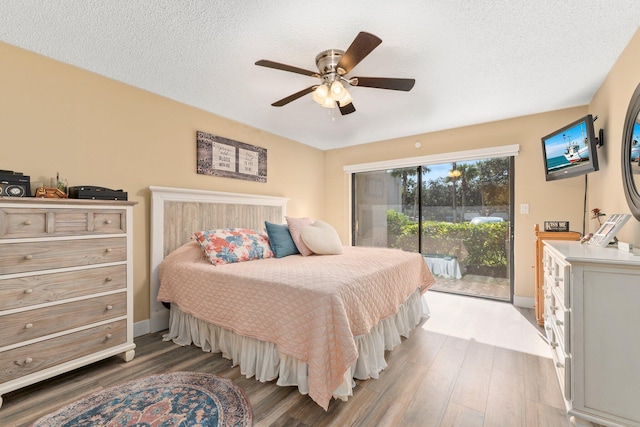 3500 Twin Lakes Ter Unit 106, Fort Pierce, FL 34951 - bedroom with a ceiling fan, wood finished floors, a textured ceiling, and access to exterior