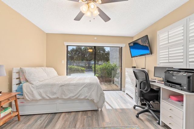 bedroom featuring a textured ceiling, light hardwood / wood-style floors, ceiling fan, and access to exterior