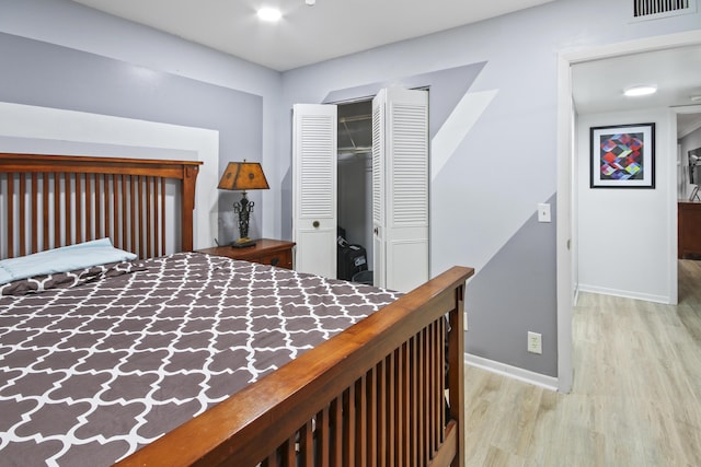 bedroom featuring light hardwood / wood-style flooring and a closet