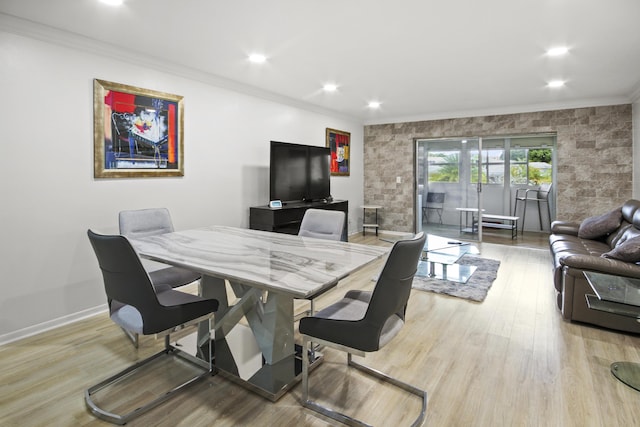 dining area with crown molding, light hardwood / wood-style floors, and french doors