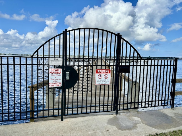 view of gate with a water view