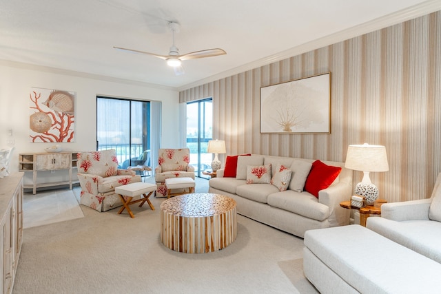 living room with ceiling fan, light colored carpet, and ornamental molding