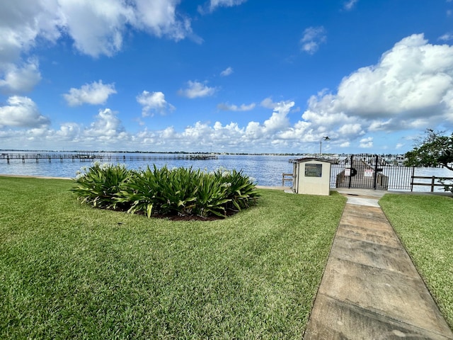 exterior space featuring a water view and a lawn