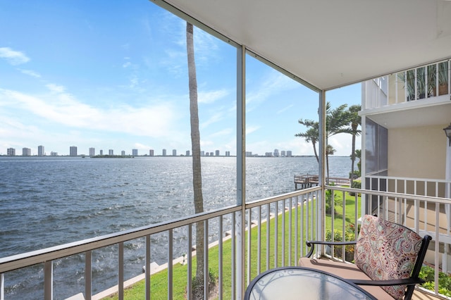 sunroom / solarium with plenty of natural light and a water view