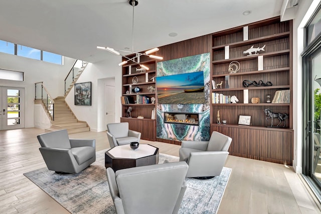 living room featuring light hardwood / wood-style floors and an inviting chandelier