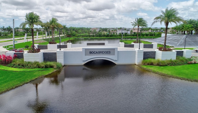 view of home's community with a yard and a water view