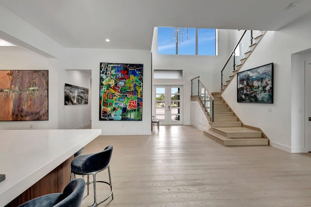 interior space with light wood-type flooring and french doors