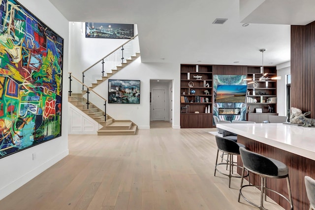 interior space with plenty of natural light, light hardwood / wood-style floors, and indoor bar