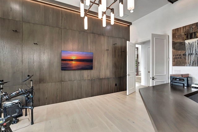 interior space with light hardwood / wood-style flooring, a chandelier, and a high ceiling