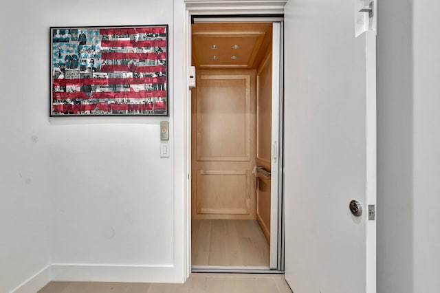 interior space with hardwood / wood-style floors and elevator