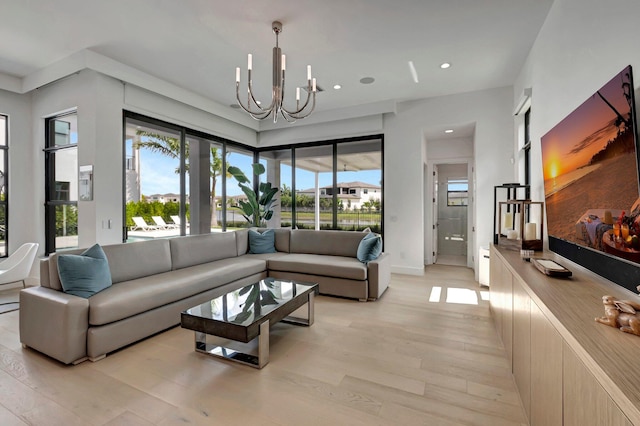 living room with a chandelier and light hardwood / wood-style floors