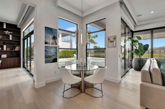 dining area featuring a high ceiling and light wood-type flooring