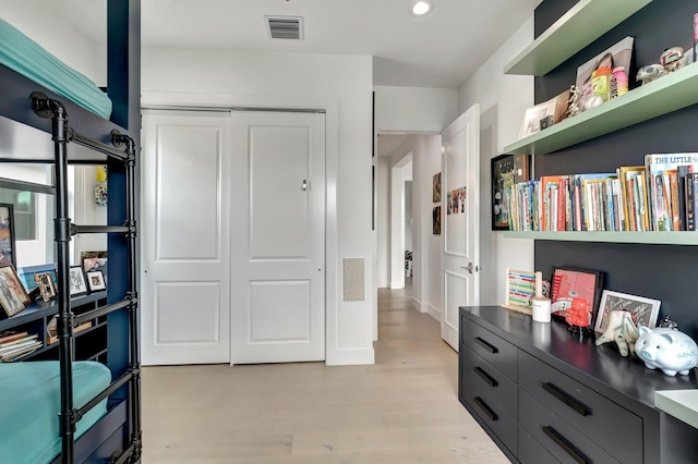 interior space with light wood-type flooring and a closet