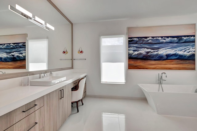 bathroom with a bathing tub, tile patterned flooring, and vanity