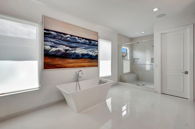 bathroom with separate shower and tub and a wealth of natural light