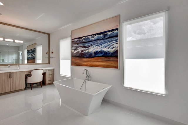 bathroom with a tub to relax in, tile patterned flooring, and vanity