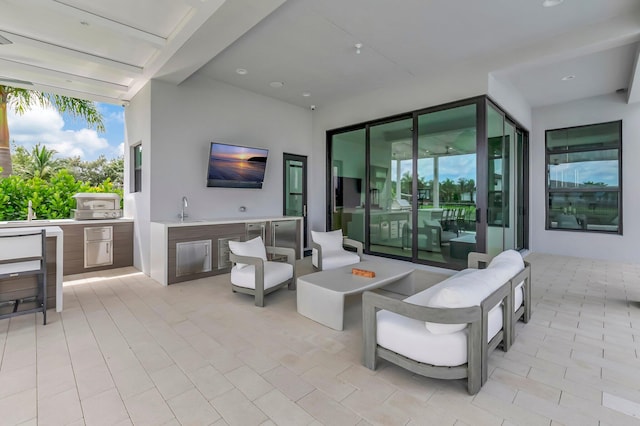 view of patio / terrace featuring sink, exterior kitchen, and a fire pit