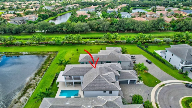 birds eye view of property with a water view