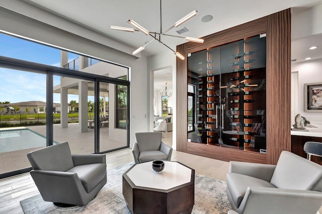 wine cellar featuring sink, a chandelier, and light wood-type flooring