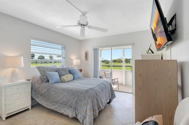 bedroom featuring light tile patterned floors, a textured ceiling, and ceiling fan