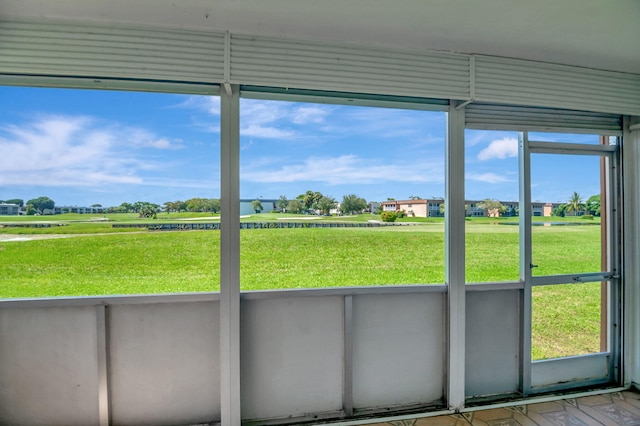 unfurnished sunroom featuring a rural view and plenty of natural light