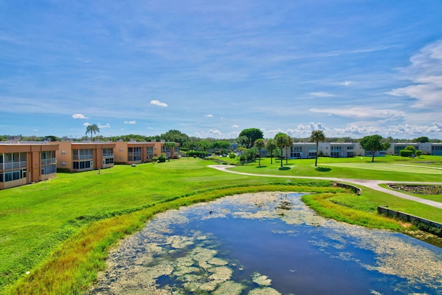 surrounding community with a lawn and a water view