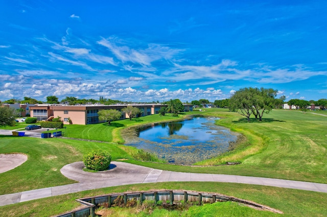 surrounding community with a lawn and a water view