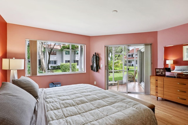 bedroom featuring light wood-type flooring and access to exterior