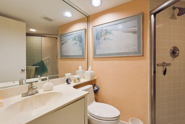 bathroom featuring an enclosed shower, vanity, and toilet