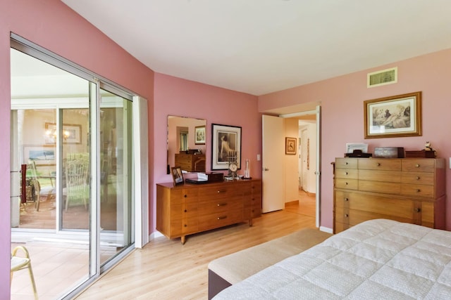 bedroom featuring access to outside and light hardwood / wood-style floors