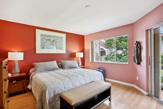 bedroom featuring light hardwood / wood-style floors and access to outside