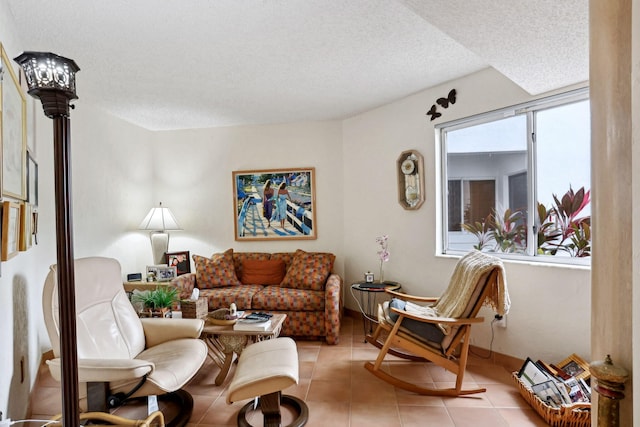 living room with a textured ceiling and light tile patterned floors