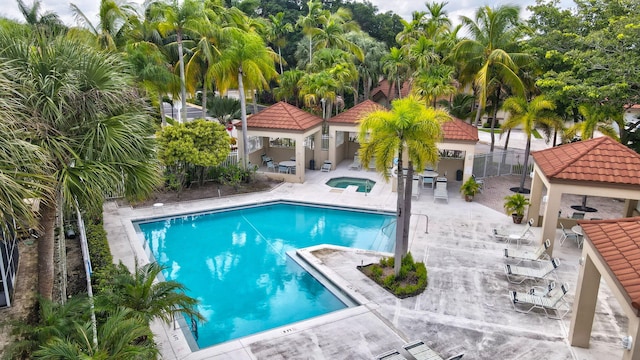 view of pool with a patio, a gazebo, and a hot tub