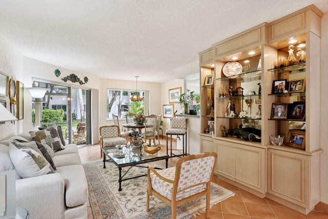 tiled living room with an inviting chandelier and a textured ceiling