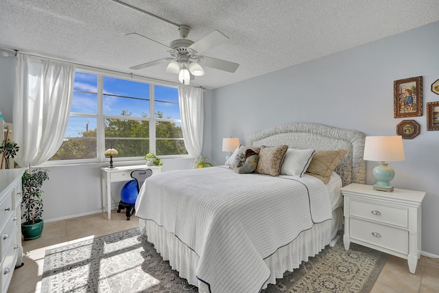 bedroom with light tile patterned flooring, a textured ceiling, and ceiling fan